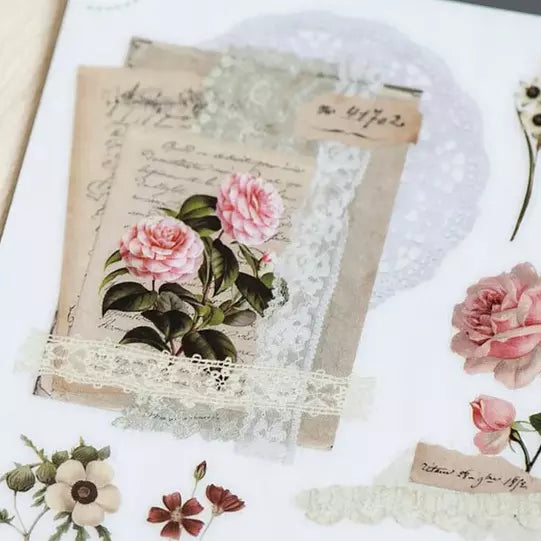 Decorative book with floral design and lace on a white background