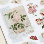 Vintage-style card with floral design and text on a textured surface.