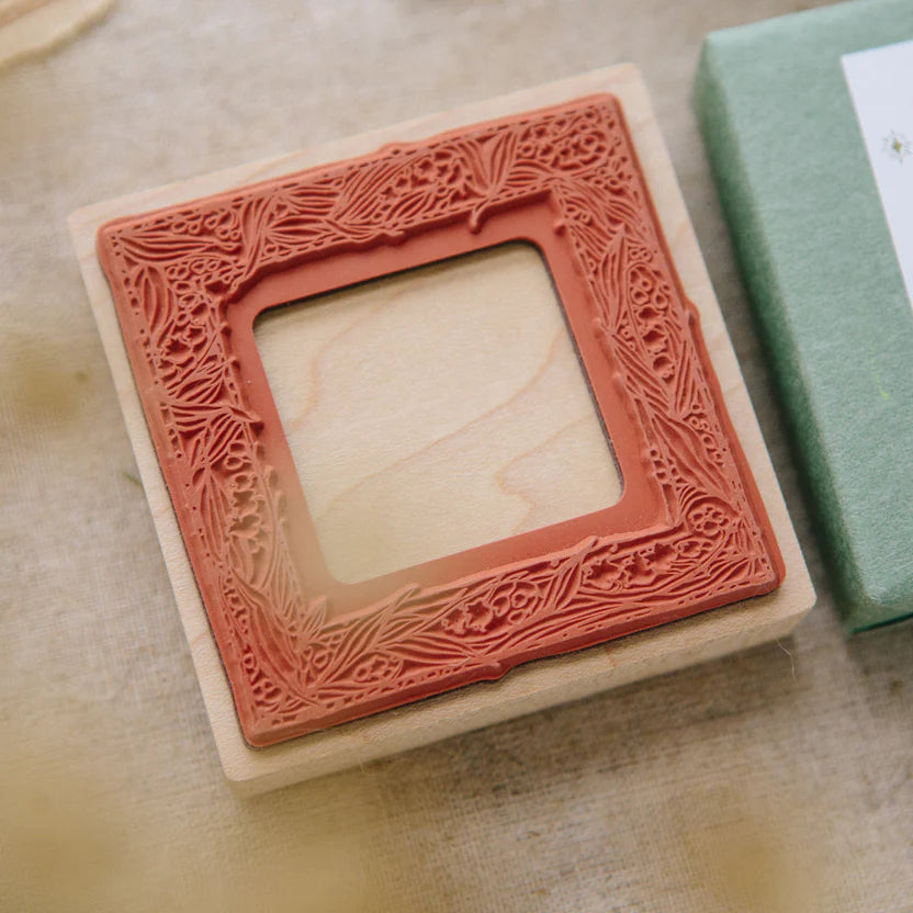 Muguet Frame Rubber Stamp impression showing its intricate floral frame on a wooden surface