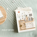 Decorative gift packaging with lace and text on a textured surface