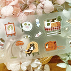 Set of cute illustrated stickers on a clear sheet with floral background