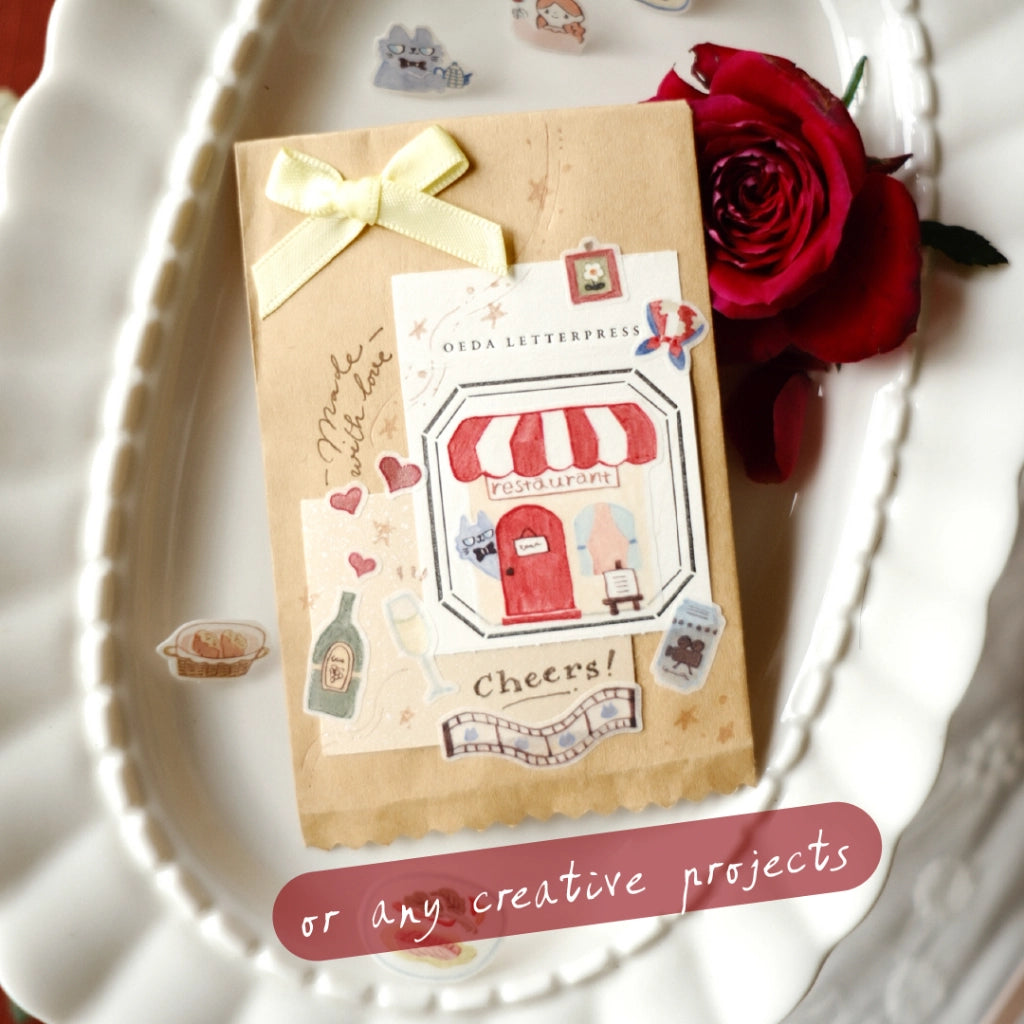 Gift package with decorative elements on a white surface with a red rose.