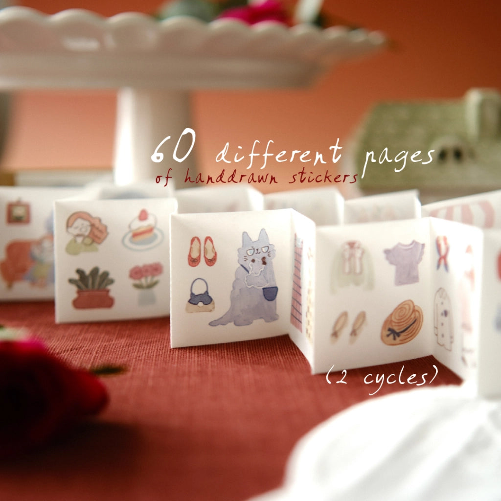 Small book with handdrawn stickers on a red surface, with text about sticker content.