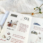 Illustrated pages with text and graphics on a textured surface with flowers.