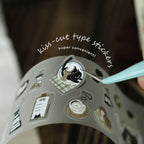 Roll of kiss-cut type stickers with a tool and text on a dark background
