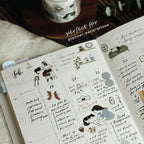 Planner with decorative stickers and text 'perfect for planner decorations' on a blurred background.