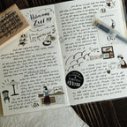 Open notebook with handwritten text and illustrations on a light surface