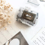 Decorative item wrapped in newspaper with a lock design on a light surface.