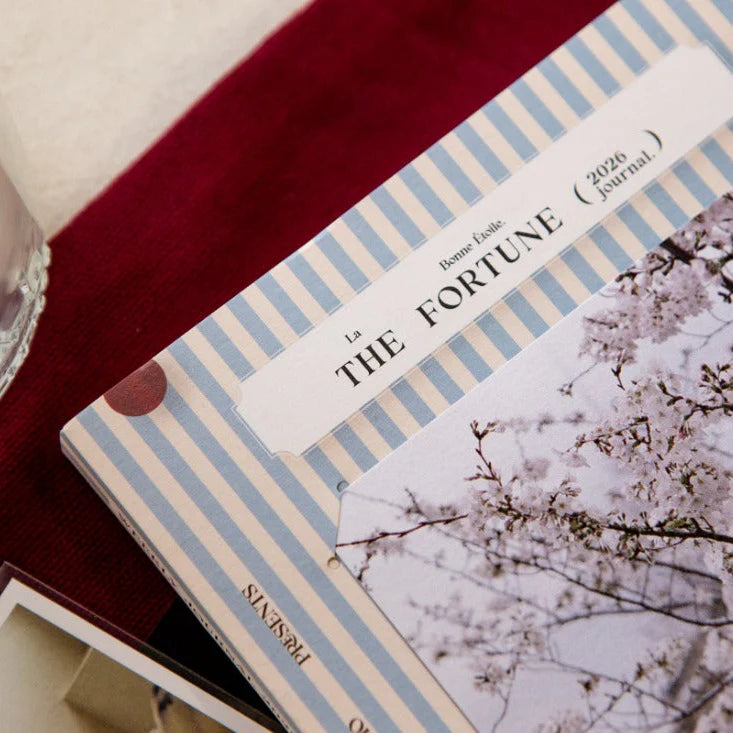 OURS Studio 2026 Research Project Journal with cherry blossom cover on a red surface