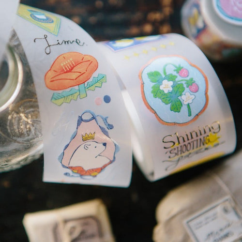 Two rolls of decorative tape with cartoon designs on a dark surface.
