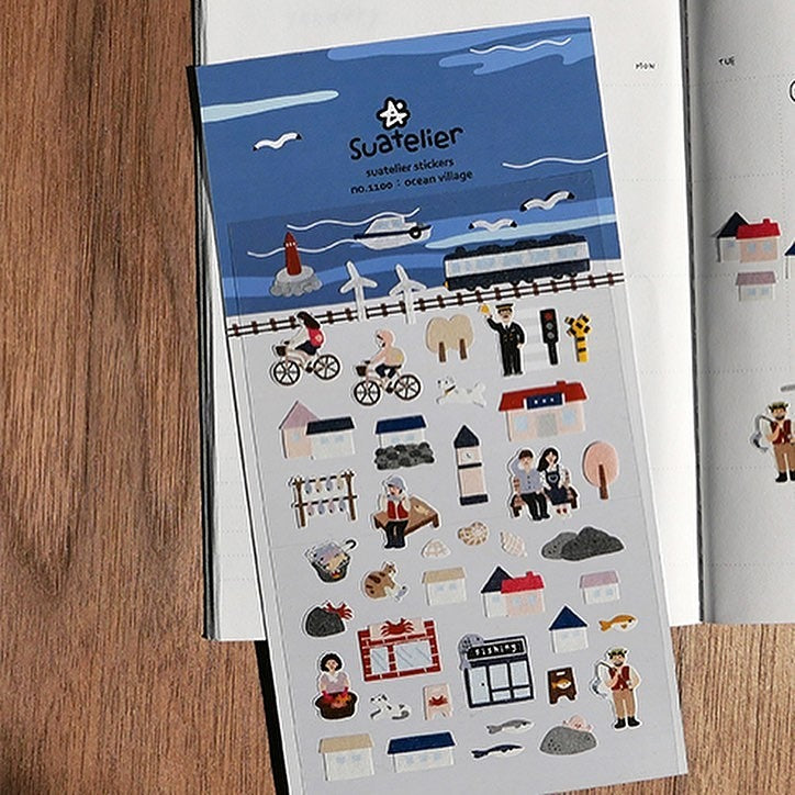 Ocean Village Sticker Sheet by Suatelier, ocean-themed design on a wooden surface