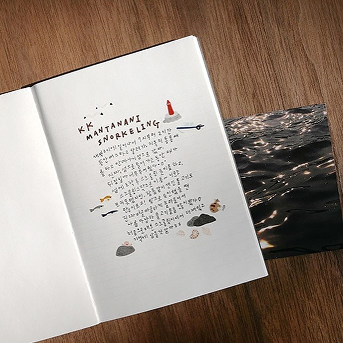 Open book with text and illustrations on a wooden surface, from the Ocean Village Sticker Sheet