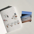 Sticker sheet with various designs and two photo prints on a light gray background