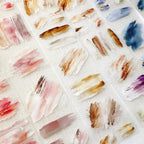Pattern of colorful brush strokes on a textured surface
