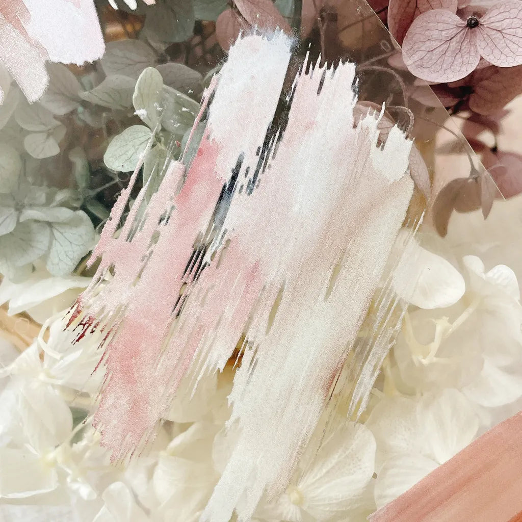 Artistic brush strokes over a floral background with hydrangeas