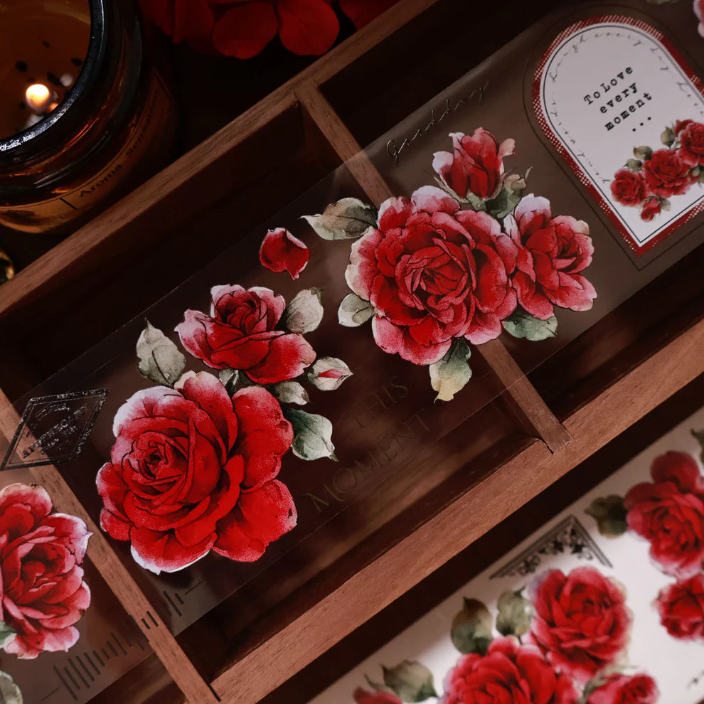 Old Days Red Paper PET Tape roses styled on wood with a candle in the background