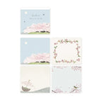 Set of cherry blossom-themed stationery items on a white background