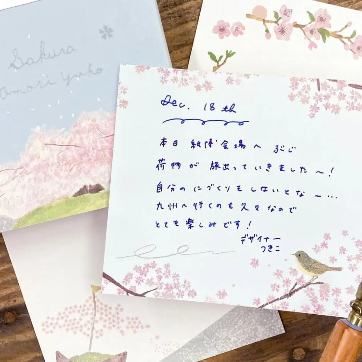 Handwritten note on Omori Yuko Sakura Memo Pad stationery with cherry blossom and bird art