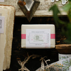 Small rectangular box with a label featuring text and graphics, placed on a textured surface.