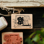 Wooden stamps with black and red designs on a rustic wooden surface.