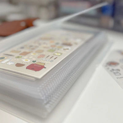 Sticker album with a sheet of stickers featuring cartoon characters on a blurred background