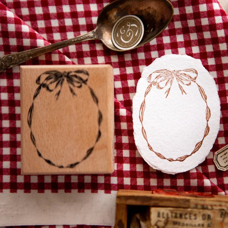 Square wooden Oval Ribbon Frame Rubber Stamp styled with vintage paper and a red wax seal