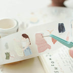 Sheet of decorative stickers with illustrations of a girl, dress, and cat on a white background.