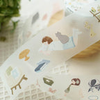 Roll of decorative paper with illustrations of people and objects on a textured surface.