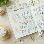 Planner with stickers and decorative elements on a textured surface