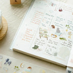 Open notebook with stickers on a textured surface
