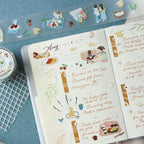 Planner with illustrated stickers on a blue surface