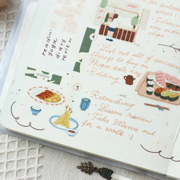 Notebook pages decorated with Palette Life 2 PET Tape artwork and text on a textured surface