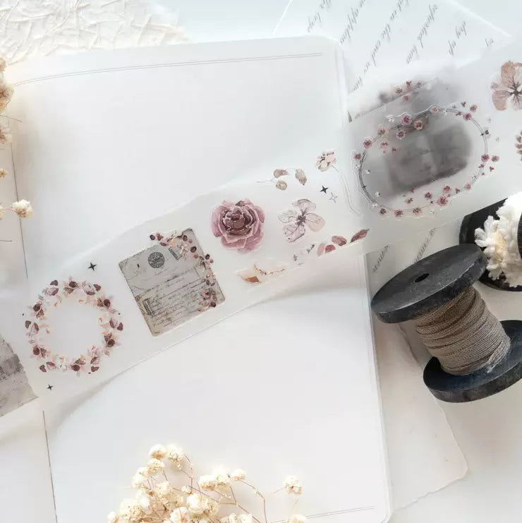 Paper Garden PET Tape floral sticker sheet with a spool of twine on a white surface