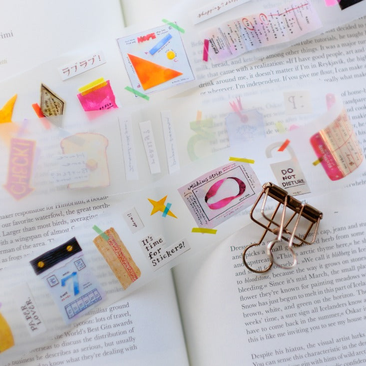 Collection of colorful Paper Lover PET Tape stationery motifs styled across an open book