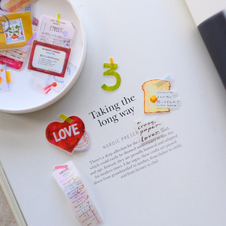 Paper Lover PET Tape stickers on a magazine page with a small dish holding more stickers