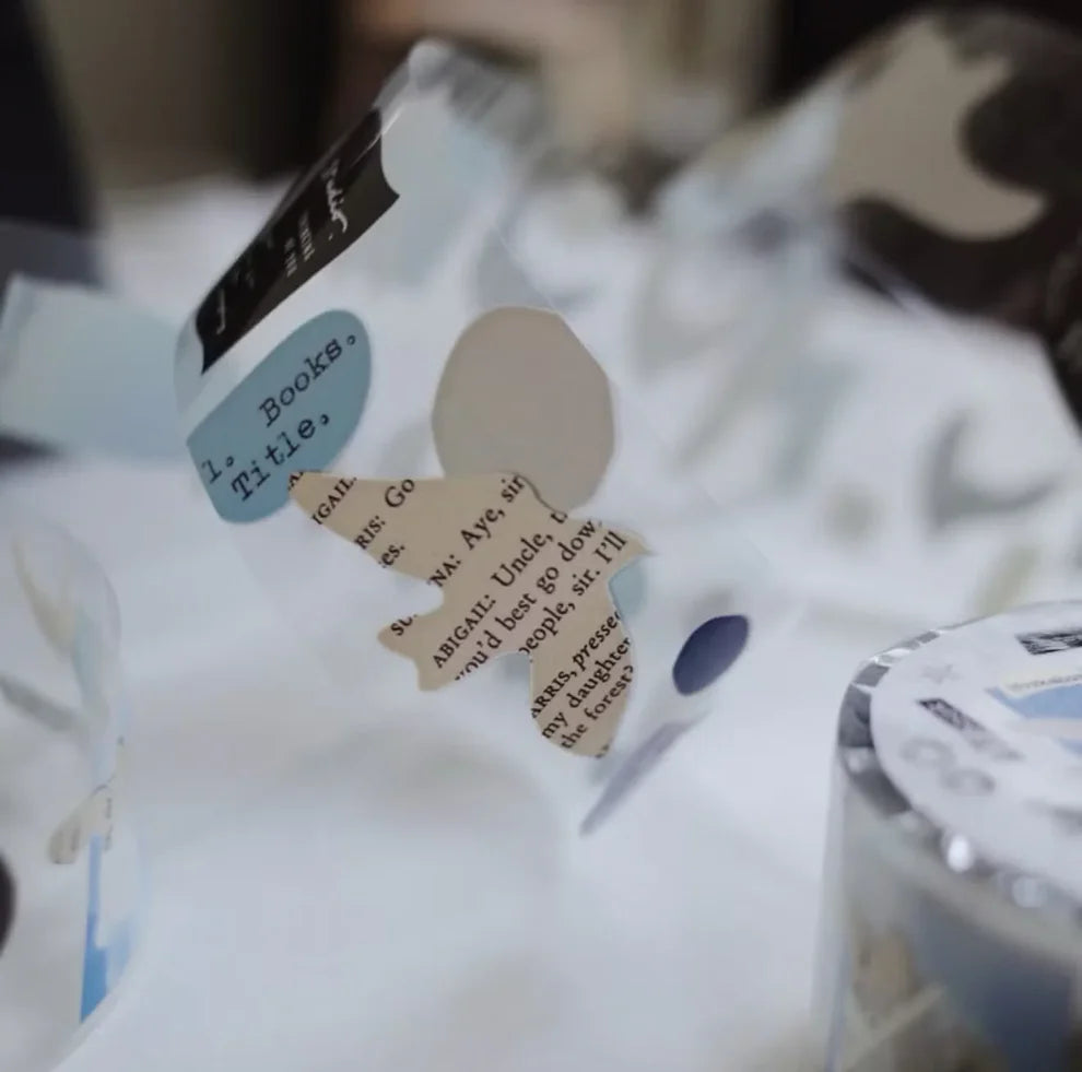 Close-up of a Papers Birds PET Tape design with text and shapes on a white background