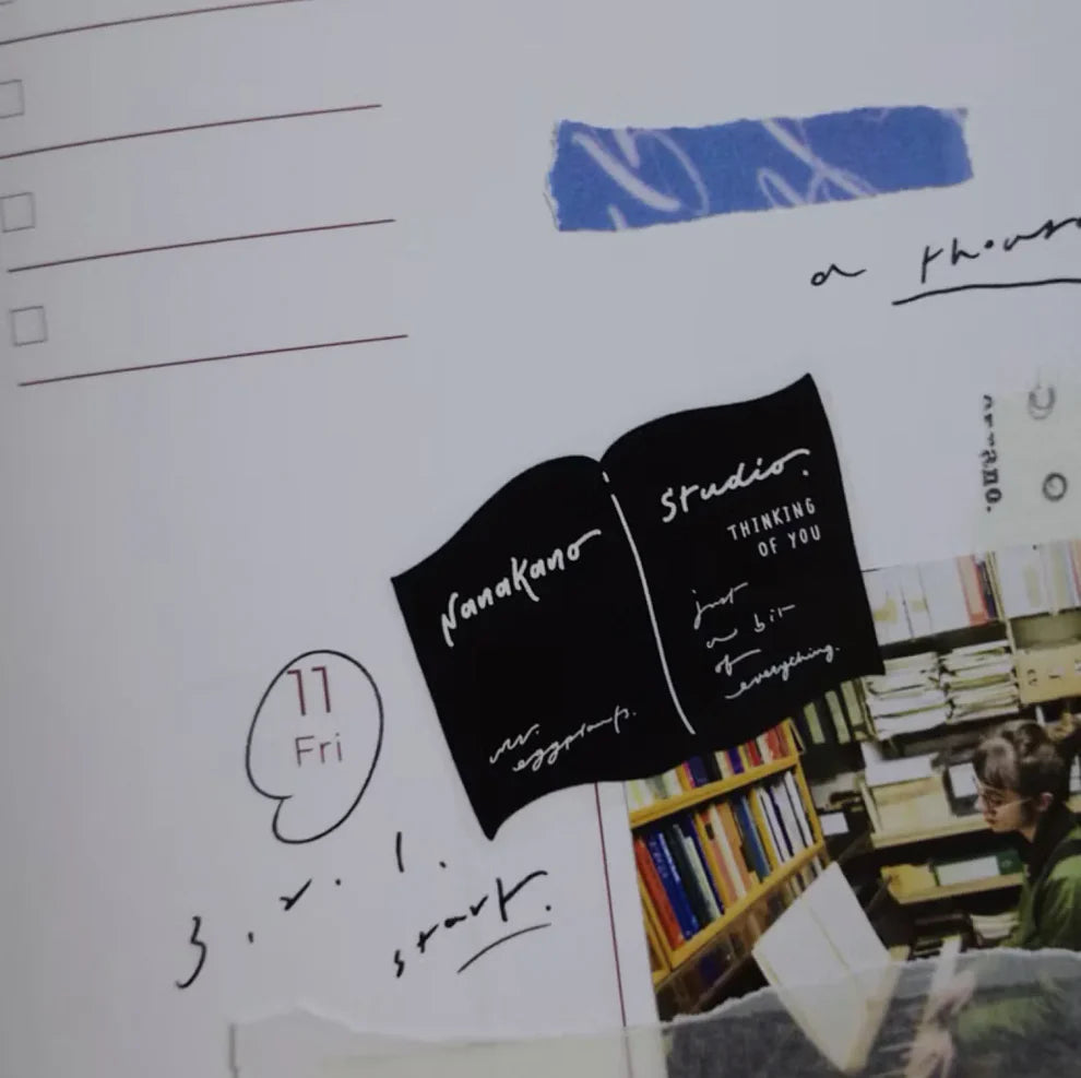 Planner decorated with Papers Birds PET Tape stickers and a library photo, close-up view