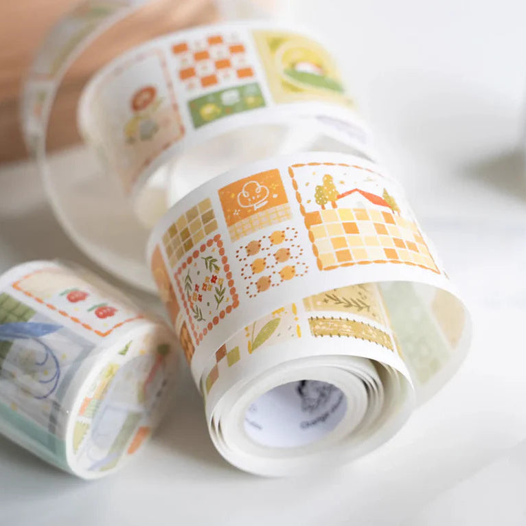 Three rolls of Patchwork Washi Tape by Orange Studio with colorful patterns on a white surface