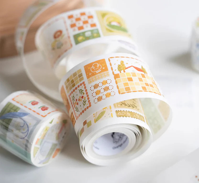Three rolls of decorative tape with patterned designs on a white surface