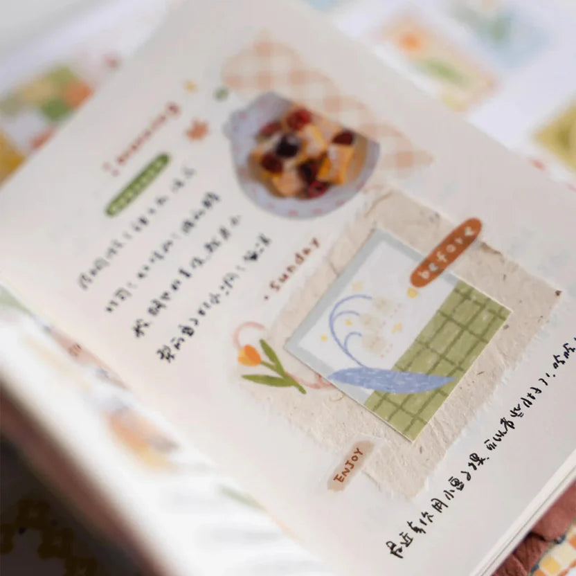 Close-up of a notebook decorated with Patchwork Washi Tape illustrations and text, soft focus