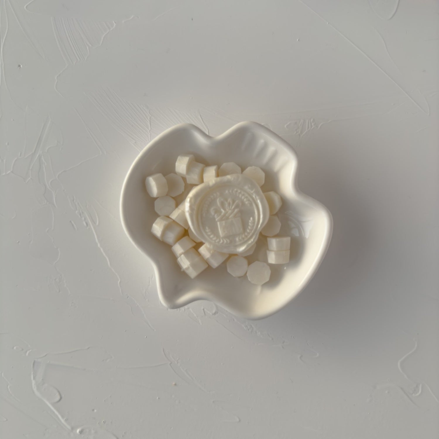 Heart-shaped dish with small white items on a gray surface