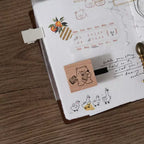 Notebook with a wooden stamp and cartoon bear design on a wooden surface