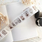 Decorative tape with floral and vintage designs on a white surface with dried flowers.