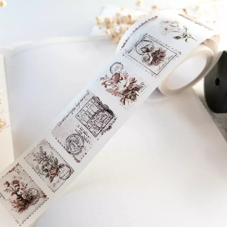 Roll of decorative tape with vintage-style designs on a white surface