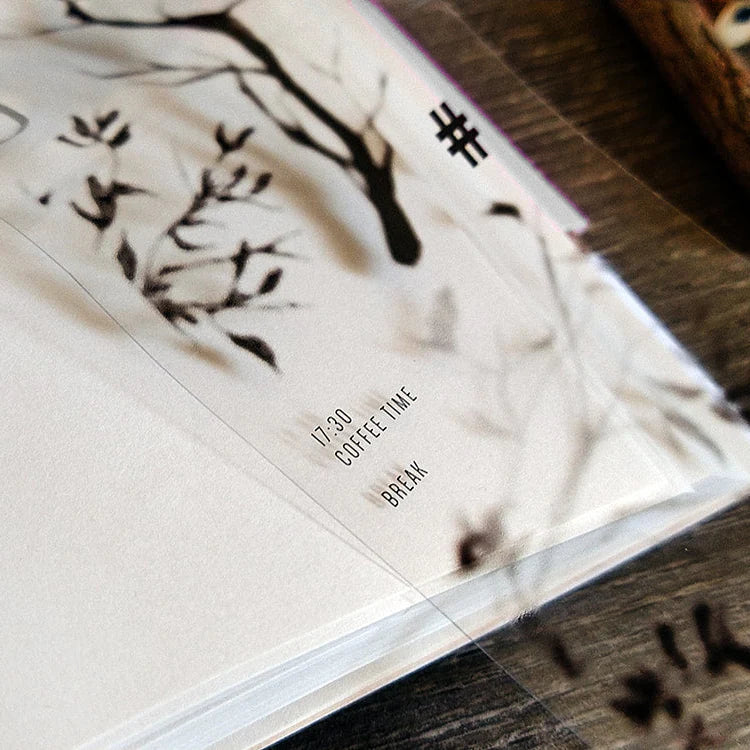 Close-up of a planner decorated with Penumbra Tree Shadow PET Tape trees and text on wood