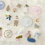 Scrapbook page decorated with blue dress girl sticker and star elements, mixed media journaling style.