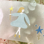 Scrapbook page decorated with blue dress girl sticker and star elements, mixed media journaling style.