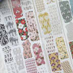 Close-up of matte PET tape stickers with vintage floral patterns in red, pink, and green tones on textured backgrounds