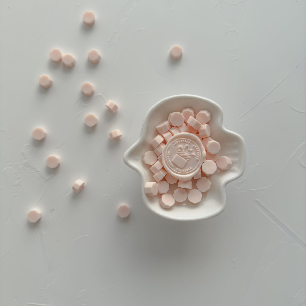 The Gift Pink Flamingo pre-made wax seals shown as bright pink pieces in a white dish