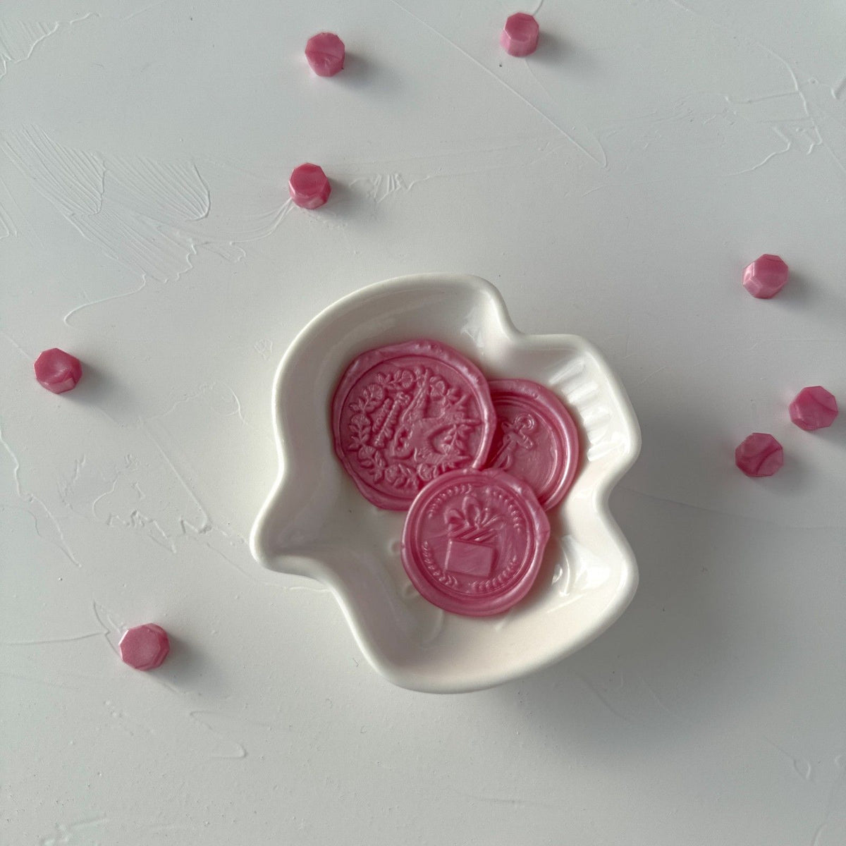 Pink Pearl Wax Beads with a stamped pearly pink wax seal displayed in a white dish on a light grey background